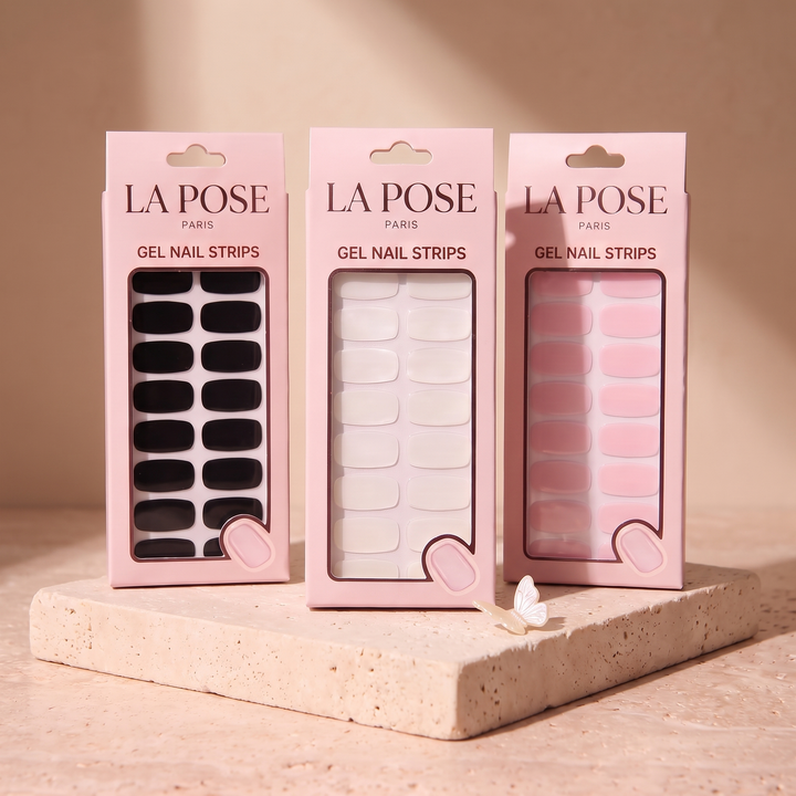 Three La Pose gel design cartons on warm stone